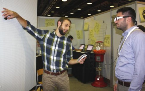 Cody Stanton, right, a packaging engineer at General Mills Inc., goes through a calibration process as part of Clemson University's CUshop, which measures consumers' reactions to products on store shelves.
